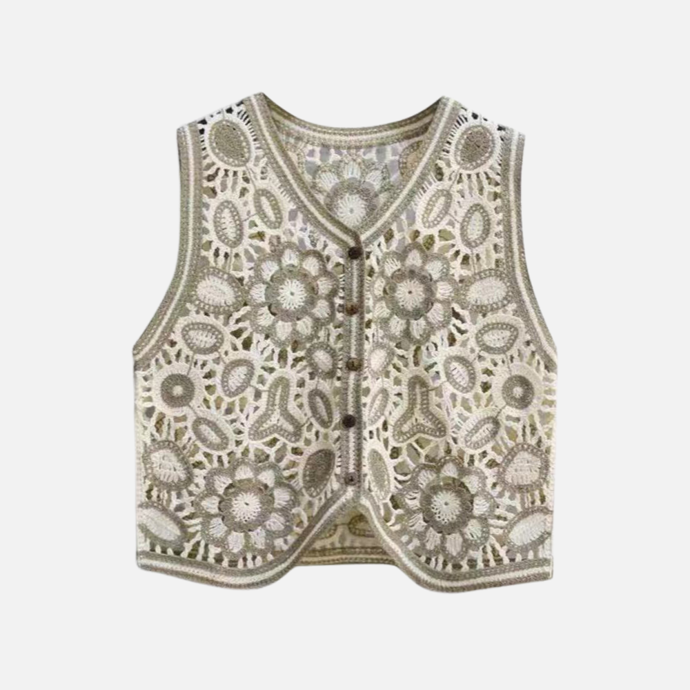 Colete Tricô Isla com estampa floral e geométrica, corte reto e botões frontais. Estilo boho, ideal para looks versáteis e modernos.

