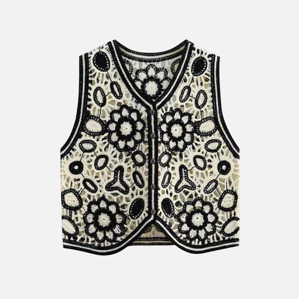 Colete Tricô Isla com estampa floral e geométrica, corte reto e botões frontais. Estilo boho, ideal para looks versáteis e modernos.

